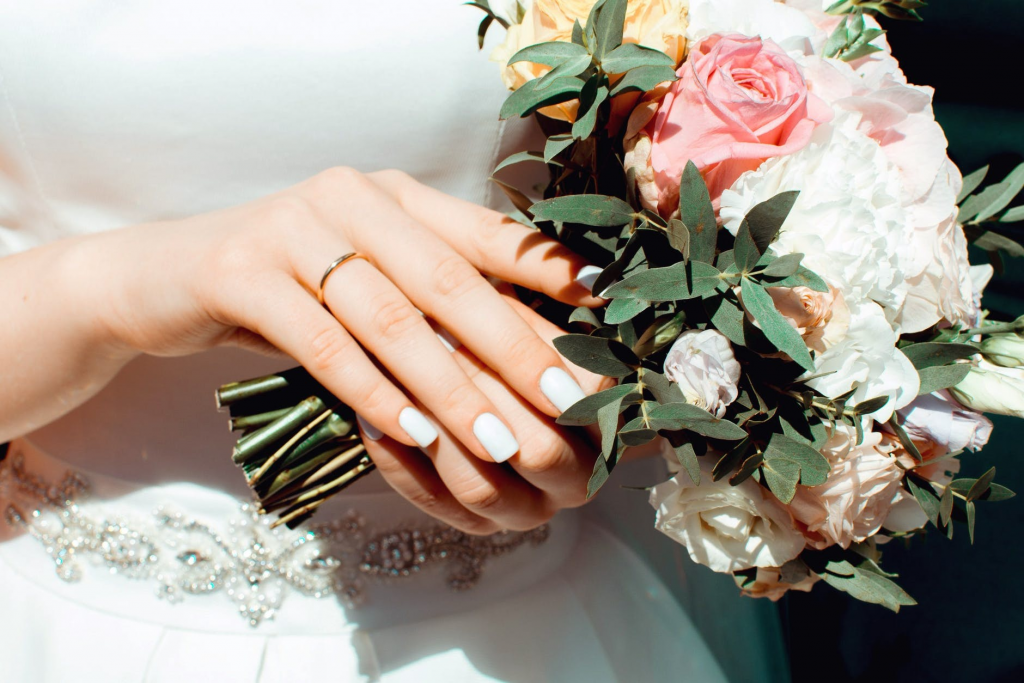 A women wears a engagement ring on her right ring finger