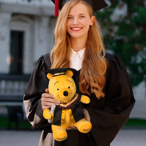 Graduate holding a bear in hand